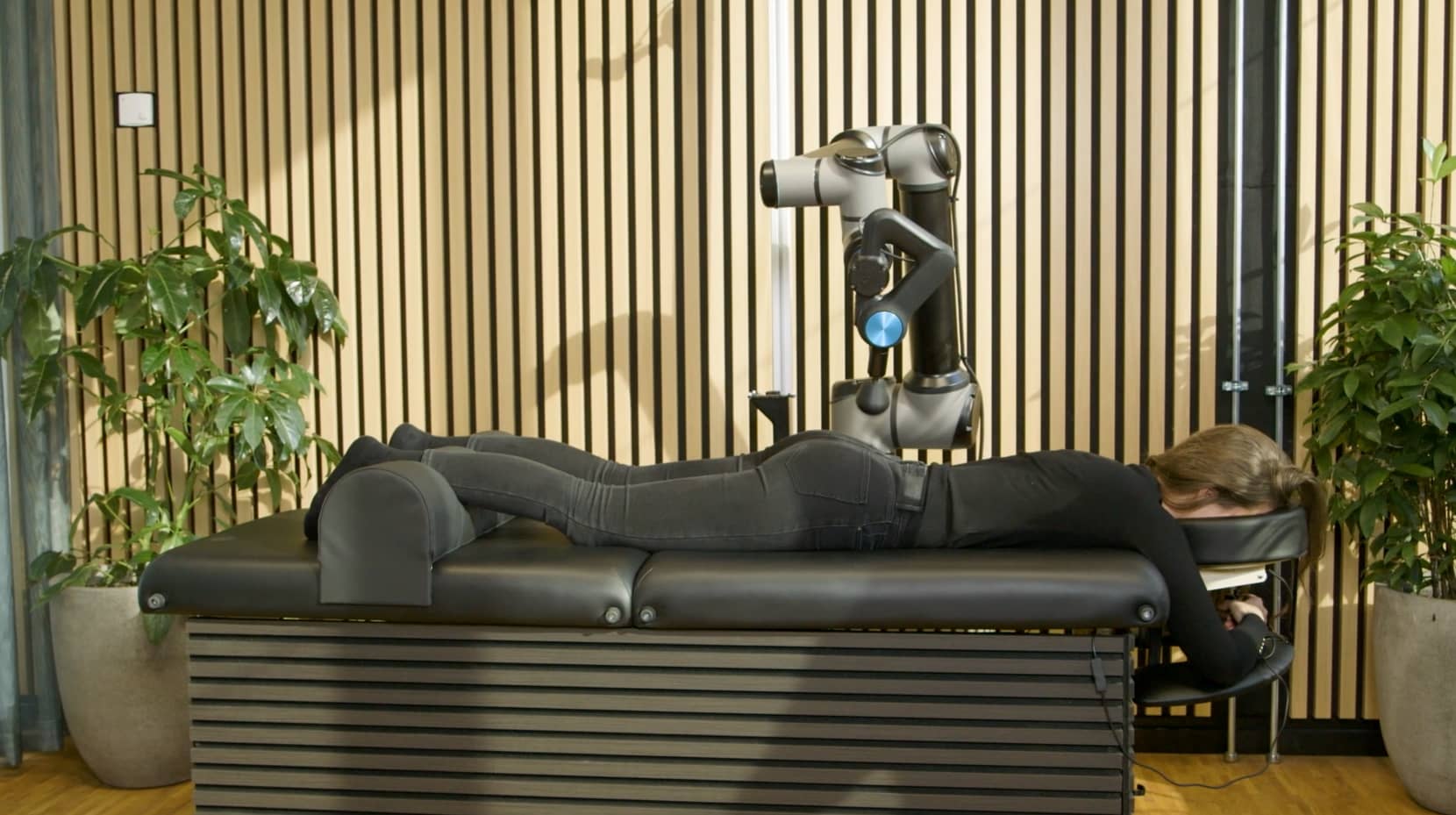A member lying fully clothed on the Self bed during a session